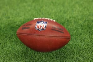 INDIANAPOLIS, INDIANA - DECEMBER 22: A detailed view of an NFL logo is seen on a football as the Tennessee Titans take on the Indianapolis Colts at Lucas Oil Stadium on December 22, 2024 in Indianapolis, Indiana.