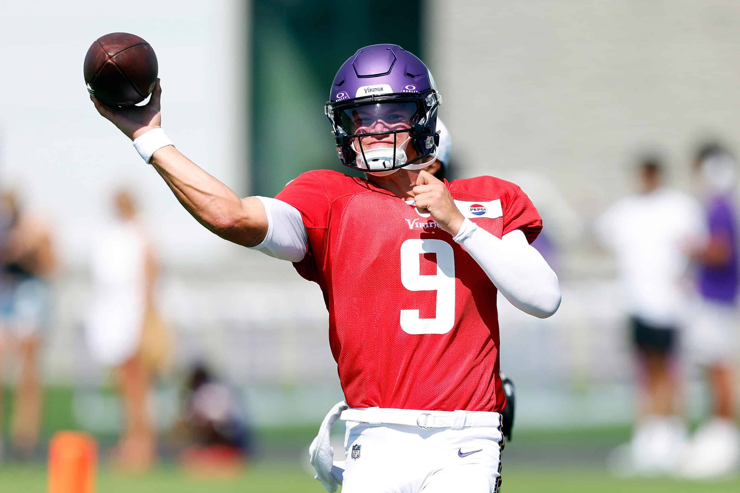 EAGAN, MINNESOTA - AUGUST 02: J.J. McCarthy #9 of the Minnesota Vikings participates in a drill during training camp on August 02, 2024 in Eagan, Minnesota.