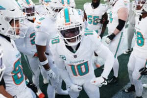EAST RUTHERFORD, NEW JERSEY - JANUARY 05: Tyreek Hill #10 of the Miami Dolphins in a team huddle before the game against the New York Jets at MetLife Stadium on January 05, 2025 in East Rutherford, New Jersey.