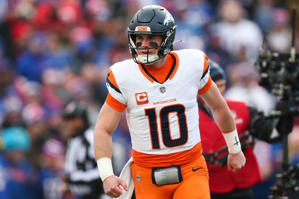 ORCHARD PARK, NEW YORK - JANUARY 12: Bo Nix #10 of the Denver Broncos celebrates after a touchdown against the Buffalo Bills during the first quarter during the AFC Wild Card Playoffs at Highmark Stadium on January 12, 2025 in Orchard Park, New York.