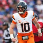ORCHARD PARK, NEW YORK - JANUARY 12: Bo Nix #10 of the Denver Broncos celebrates after a touchdown against the Buffalo Bills during the first quarter during the AFC Wild Card Playoffs at Highmark Stadium on January 12, 2025 in Orchard Park, New York.