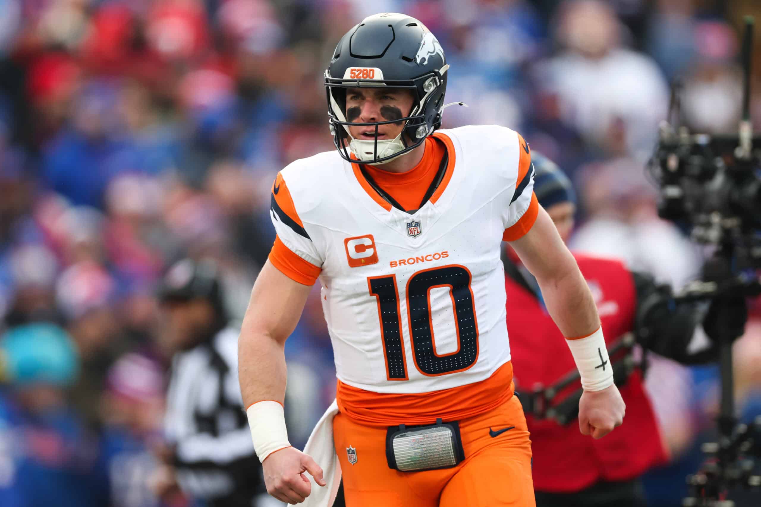 ORCHARD PARK, NEW YORK - JANUARY 12: Bo Nix #10 of the Denver Broncos celebrates after a touchdown against the Buffalo Bills during the first quarter during the AFC Wild Card Playoffs at Highmark Stadium on January 12, 2025 in Orchard Park, New York.