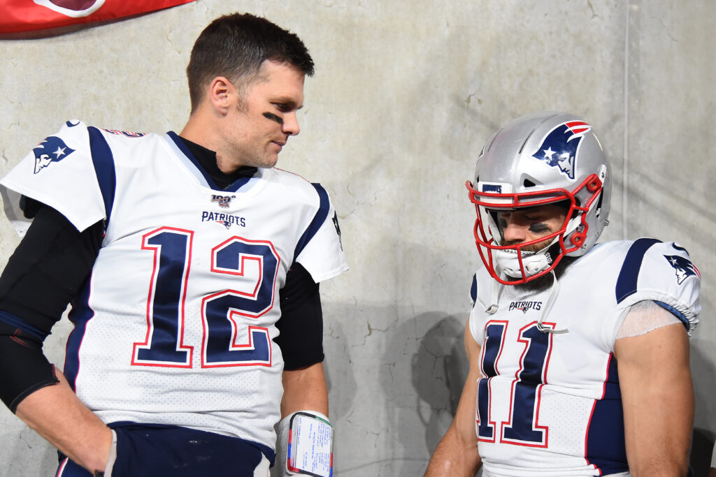 BALTIMORE, MARYLAND - NOVEMBER 03: Quarterback Tom Brady #12 of the New England Patriots looks on with teammate wide receiver Julian Edelman #11 before playing against the Baltimore Ravens at M&T Bank Stadium on November 3, 2019 in Baltimore, Maryland.