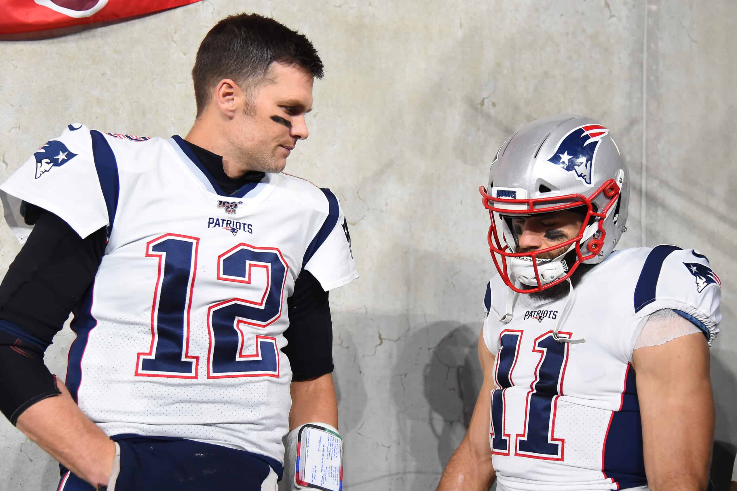 BALTIMORE, MARYLAND - NOVEMBER 03: Quarterback Tom Brady #12 of the New England Patriots looks on with teammate wide receiver Julian Edelman #11 before playing against the Baltimore Ravens at M&T Bank Stadium on November 3, 2019 in Baltimore, Maryland.
